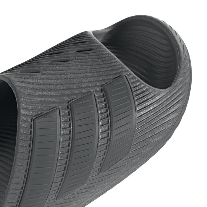 Grey slide sandal side view with textured straps and cushioned footbed