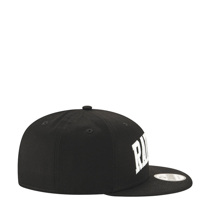 Black baseball cap with partial white Raiders lettering on the side