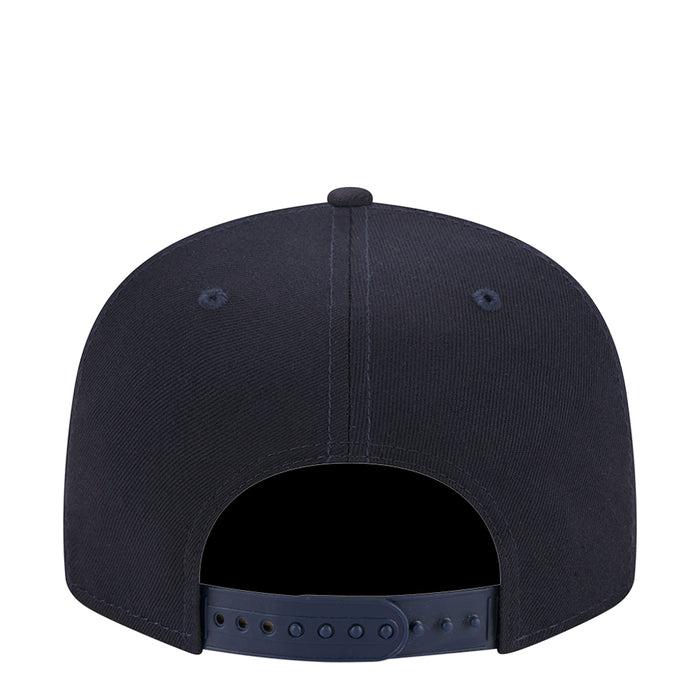 Navy junior baseball cap back view with adjustable strap and eyelets
