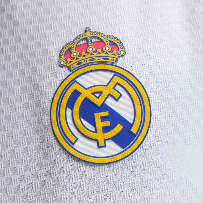 Real Madrid club crest patch with gold crown and blue emblem on jersey