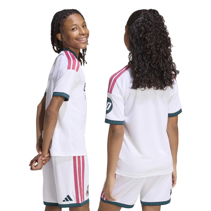 Back view youth Real Madrid home soccer jersey and shorts in white with pink stripes and teal trim