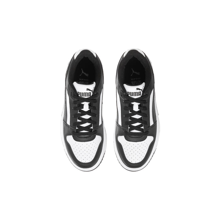 Pair of youth lace-up sneakers, black and white uppers with PUMA branding at tongue
