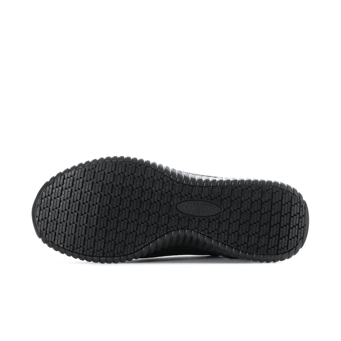 Black rubber outsole with grid tread pattern and center logo, one sneaker bottom view