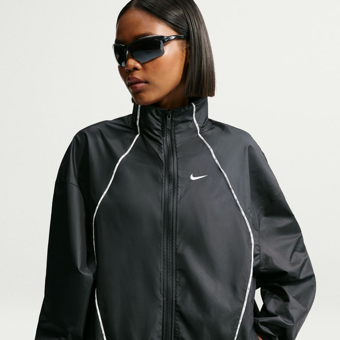 Women's black windbreaker jacket with full-zip front and white contrast piping
