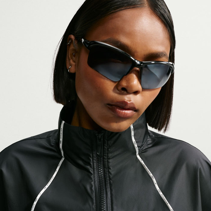 Women's black windbreaker jacket close-up with high collar and zip front detail