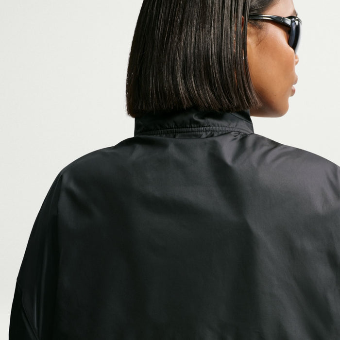 Women's black windbreaker jacket back view with stand collar and smooth fabric