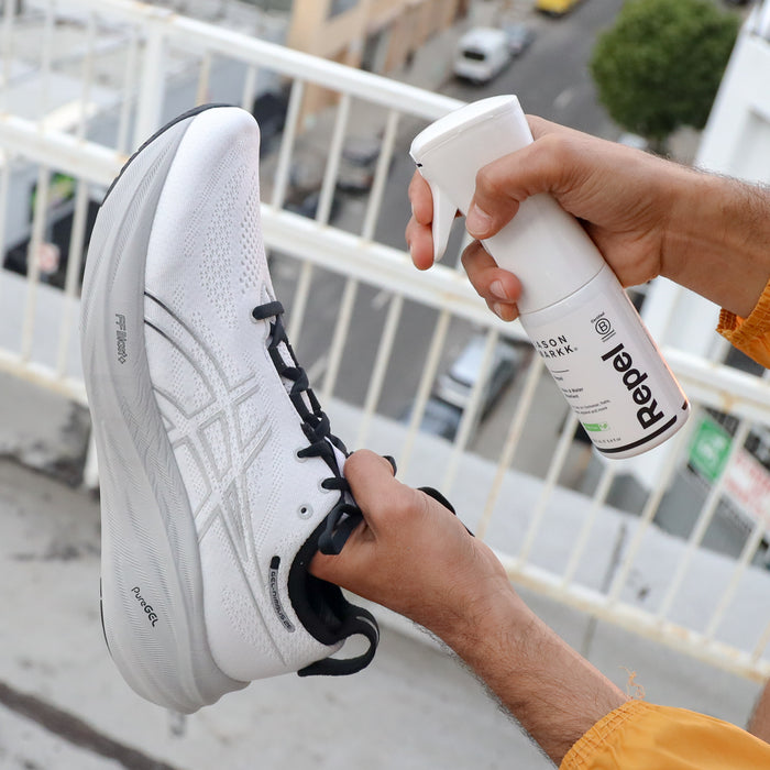 Repel protectant spray applied to a white sneaker toe and laces