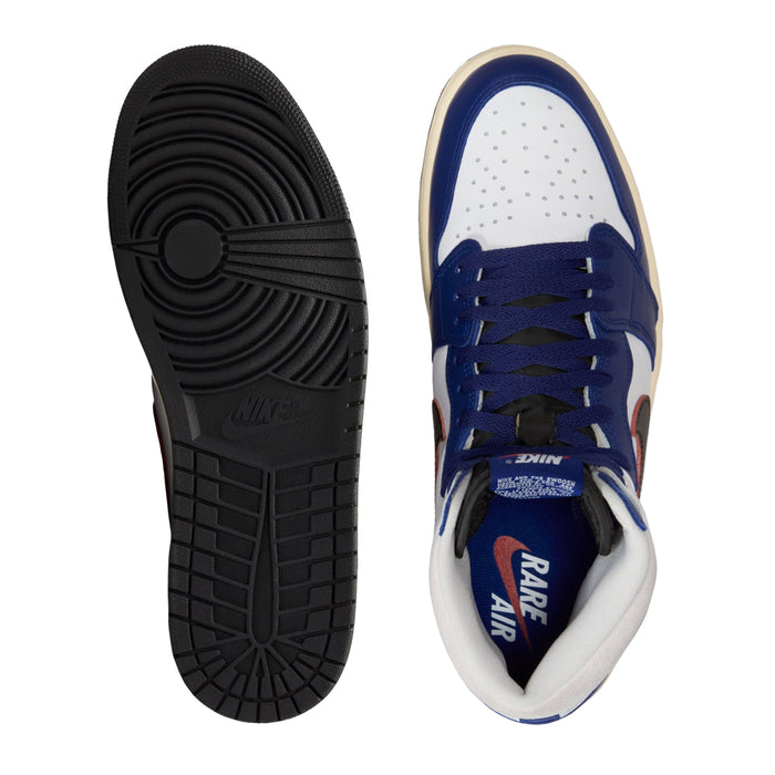 Shoe outsole and inner side, dark rubber tread with blue-and-white upper