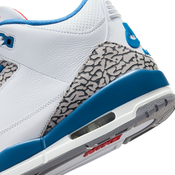Men's sneaker side close-up with elephant print, blue midsole, and visible Air window