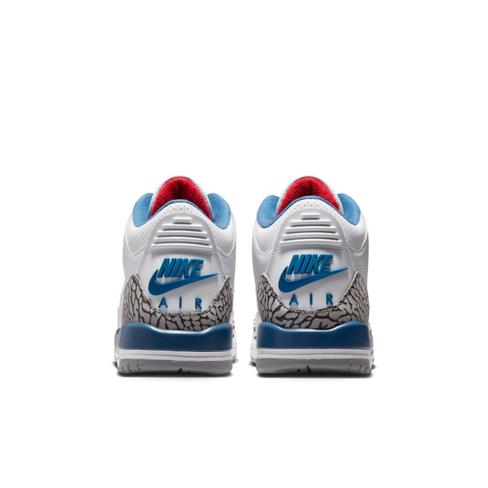 Youth white leather sneakers with Nike Air heel text, blue midsole, and elephant-print panels