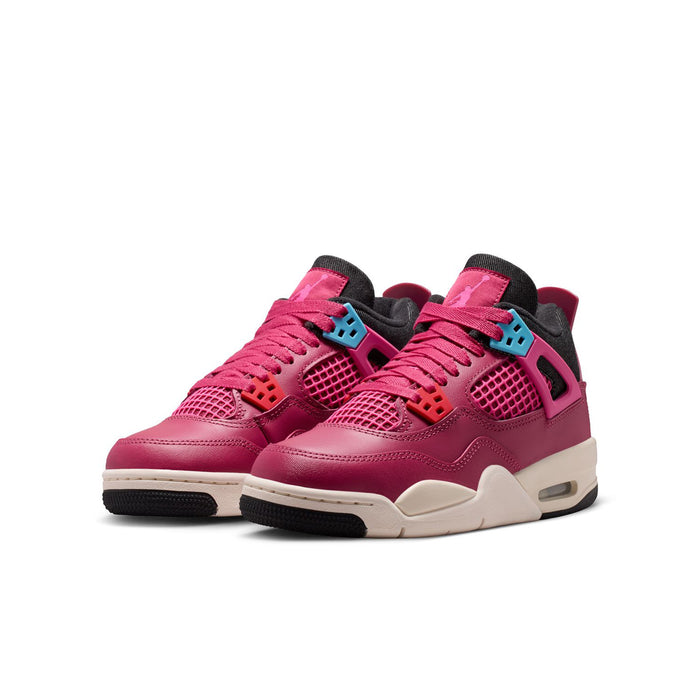 Pair of youth pink sneakers with lace-up front, black accents, and white sole
