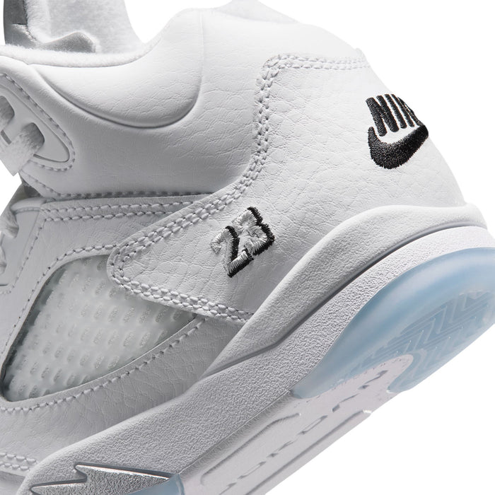 Kids white sneaker side close-up with black logo and textured midsole