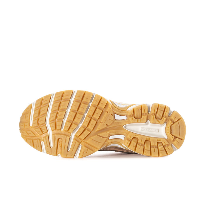 Women’s sneaker outsole view with tan rubber tread and white midsole edge