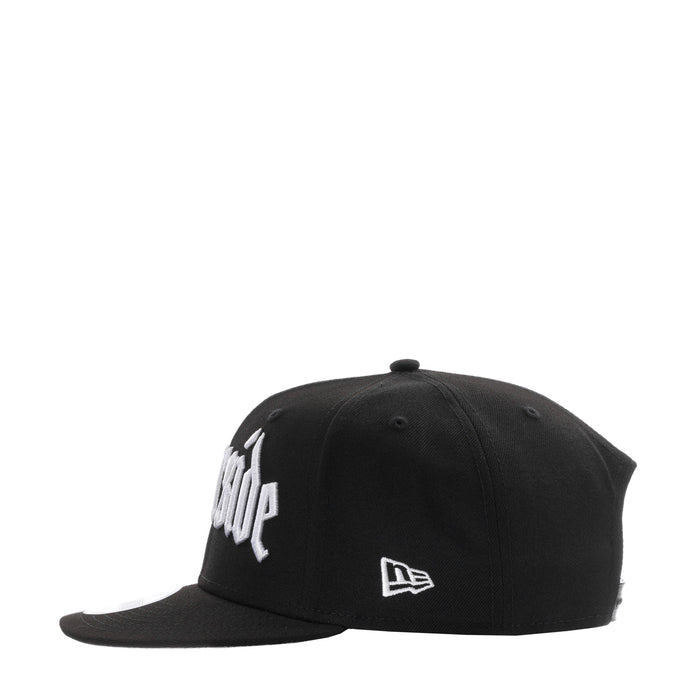 Black snapback cap with white front logo and New Era flag emblem