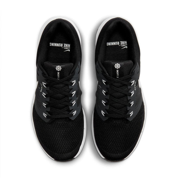 Black lace-up sneakers with mesh uppers and white logo text at the tongue.