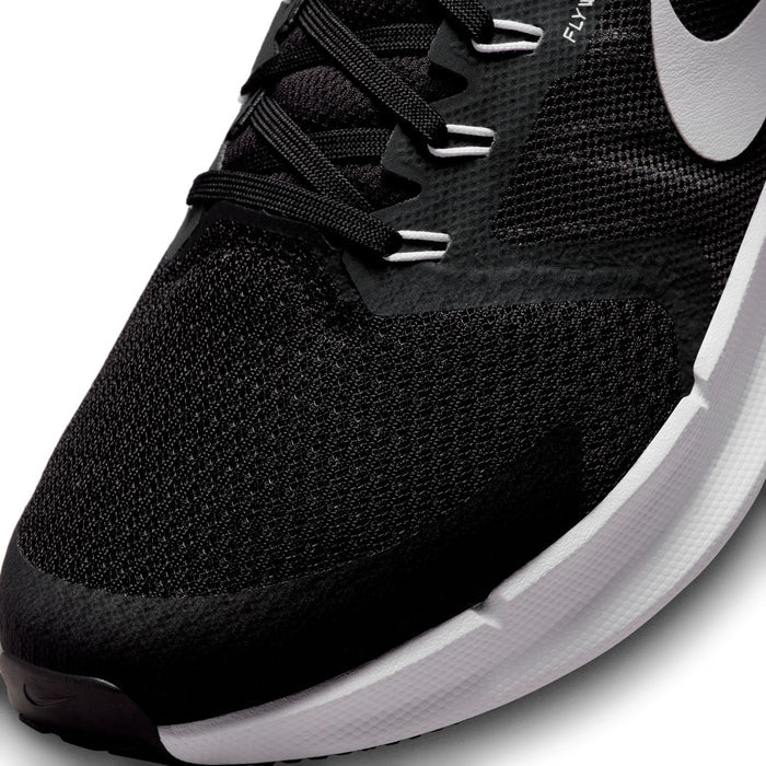 Black knit upper close-up with lace-up eyelets and white Nike swoosh detail.
