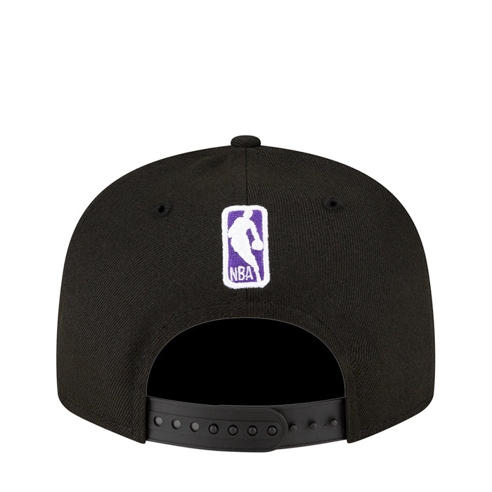 Black snapback baseball cap back view with small purple NBA logo patch