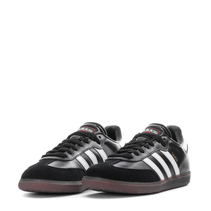 Youth adidas sneakers, black with white stripes and gum outsole (pair view)