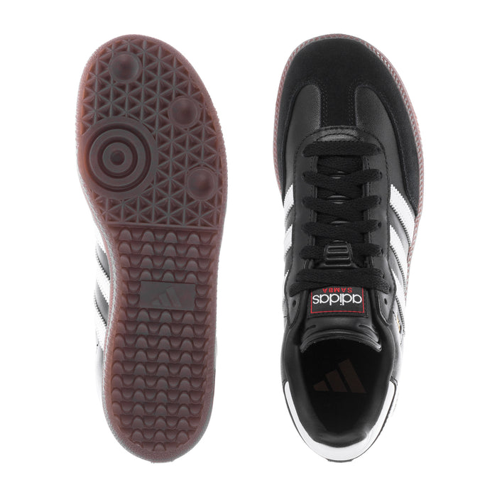 Youth adidas sneakers, outsole tread view and black upper with white stripe