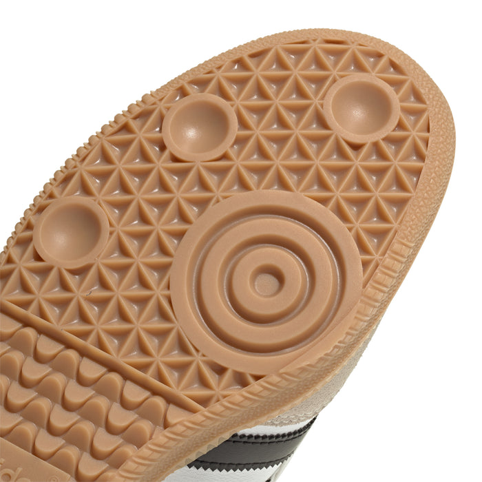 Close-up tan gum outsole with textured grip pattern and adidas logo circle
