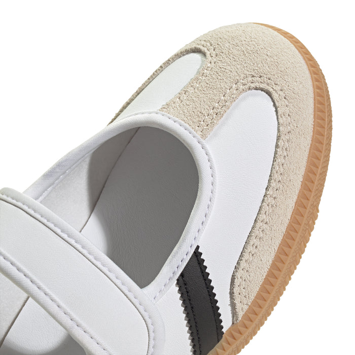 Close-up of youth sneakers: white upper with beige suede panel and black stripe