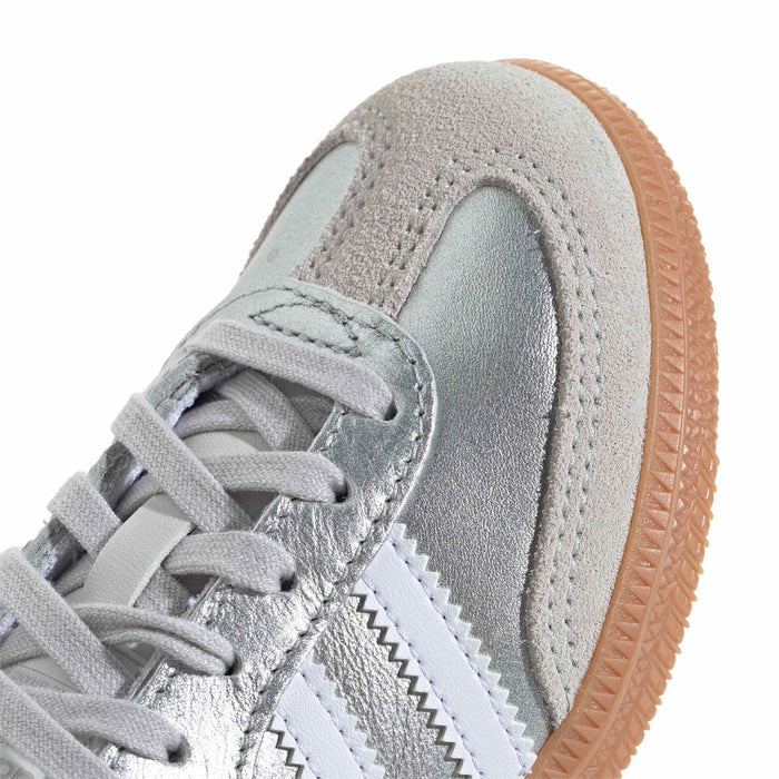 Kids sneaker toe and laces detail; silver suede and stitched overlays with gum edge