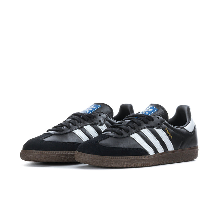 Black adidas Samba OG sneakers with white three-stripe design, black laces, gum sole.