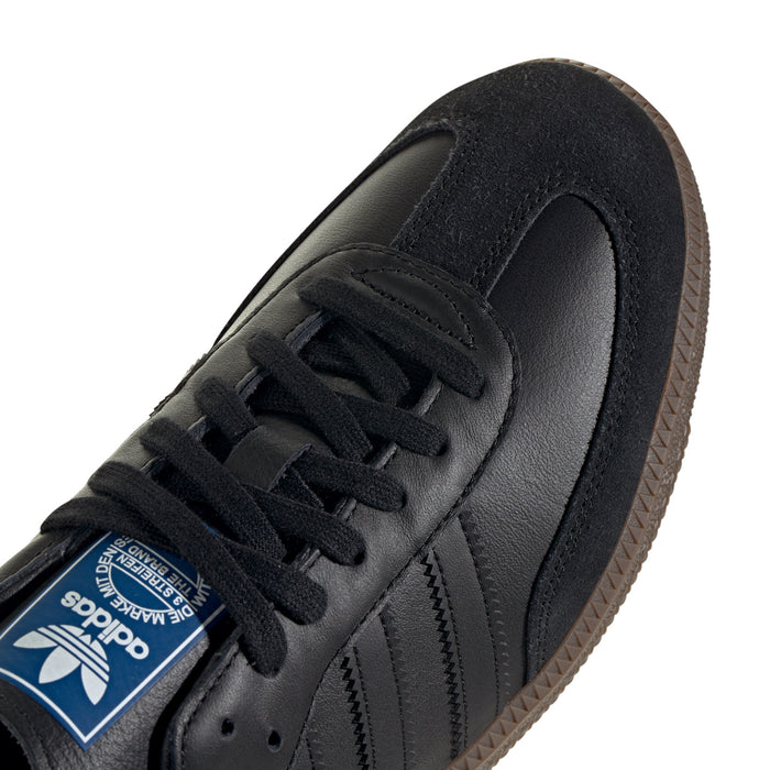 Close-up of black adidas Samba OG sneaker laces, adidas label, and side panel
