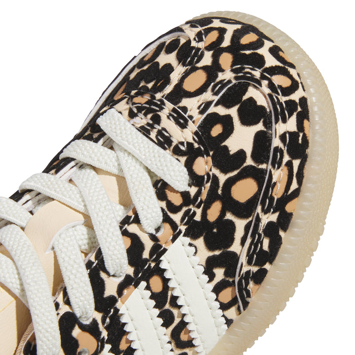Toddler sneaker close-up: leopard print upper, white laces, tan suede heel tab