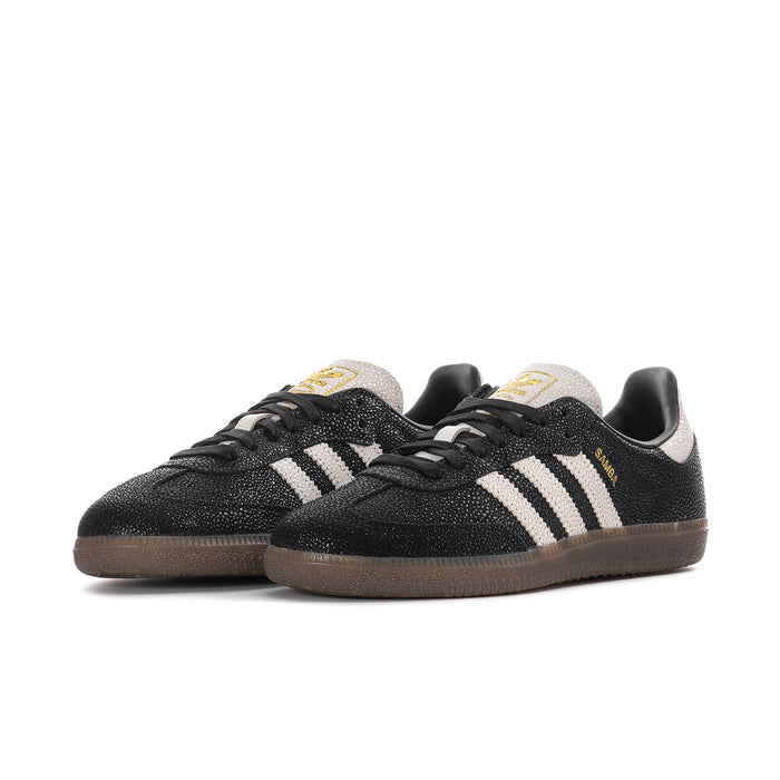 Black womens Adidas Samba OG sneakers, side view with white stripes and gum outsole