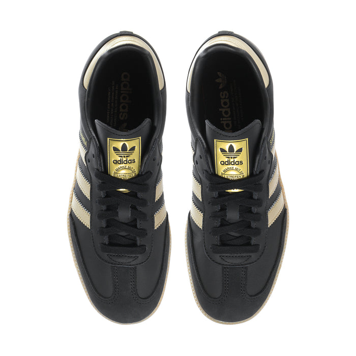 Samba OG women's sneakers laced top view, black with gold Adidas branding on tongue