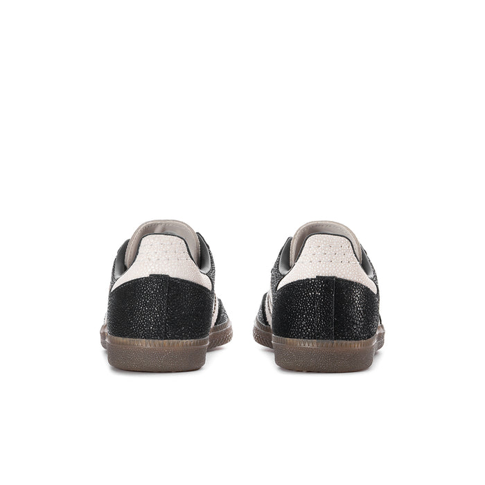 Black Adidas Samba OG sneakers with white heel trim and gum-brown outsole