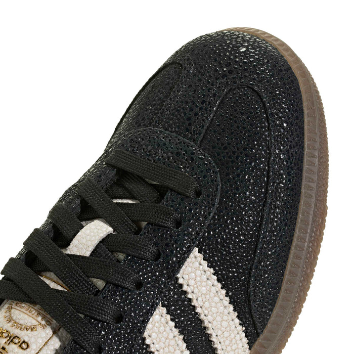 Black textured Adidas Samba OG upper with white stripes and lace-up detail
