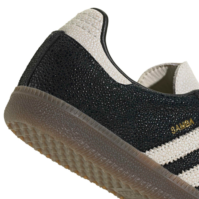 Black-and-white Adidas Samba OG sneaker side with gum sole and textured upper