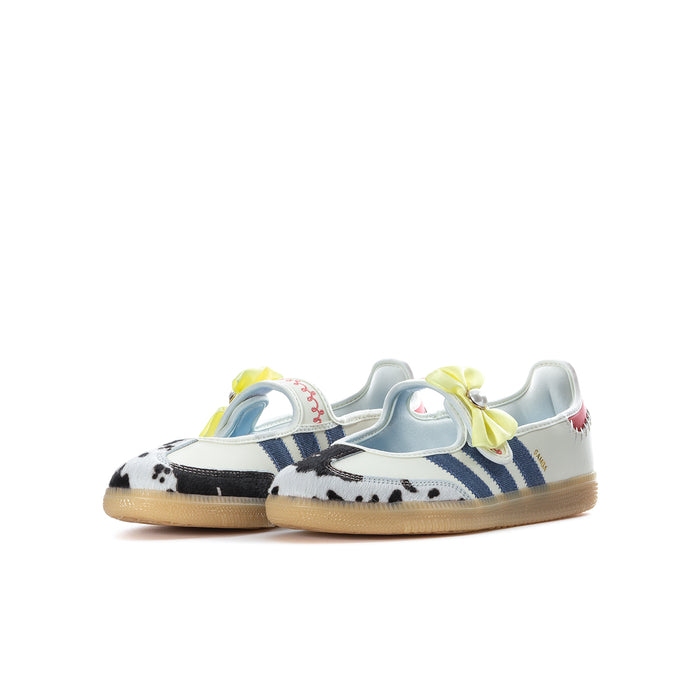 Youth low-top sneaker with cream upper, blue stripes, black cow-print, yellow bow, gum sole.