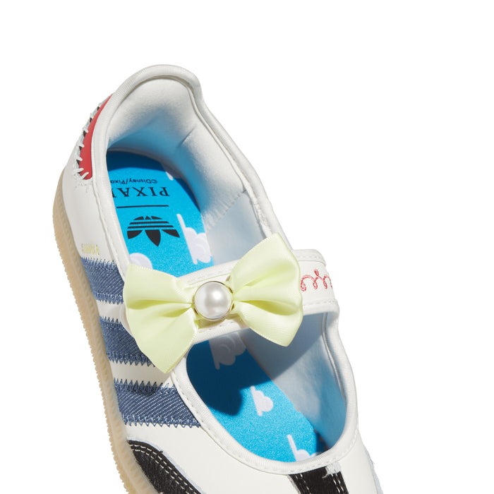 Youth sneaker interior close-up with light blue lining, yellow bow, and red lace accents.