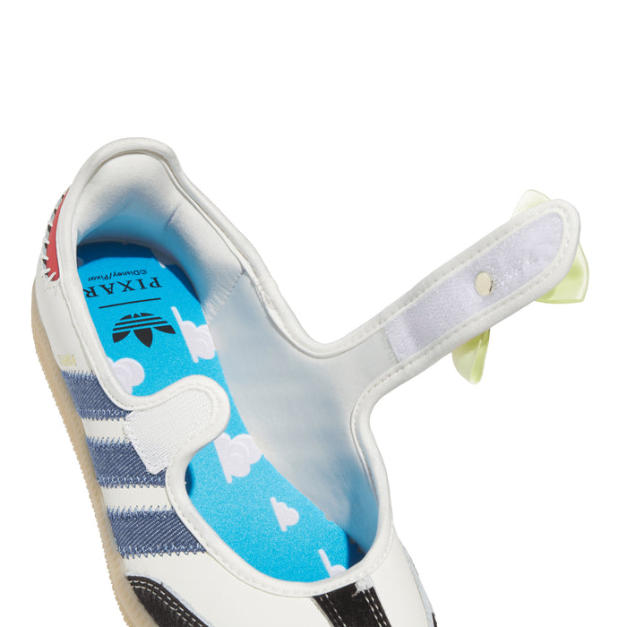 Youth sneaker side close-up with light blue interior, white upper, blue stripe panel, bow tab.