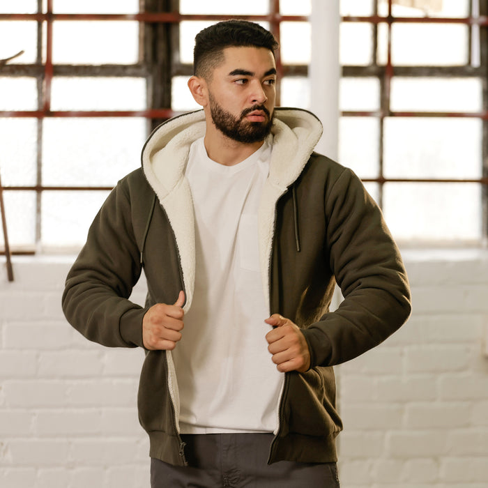 Men's olive sherpa-lined full-zip hoodie with sherpa hood lining, worn by model