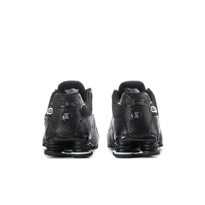 Men's black Nike sneakers, rear view with heel cushioning and Shox-style pods