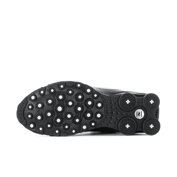 Men's black sneaker outsole with rubber traction pods and circular tread pattern