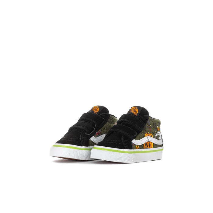 Pair of toddler black high-top sneakers with Velcro straps, monster face graphic, green trim