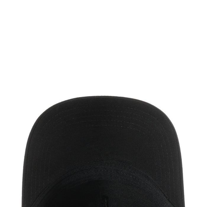 Black trucker cap crown close-up with stitched seam and raised panel