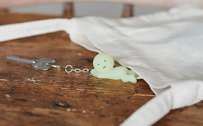 Smiski Keychain featuring a tiny glowing figure, perfect for keeping your keys secure and easy to find in the dark.