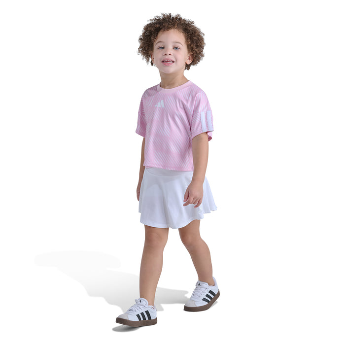 Kids pink striped soccer jersey top with white skort skirt, front view