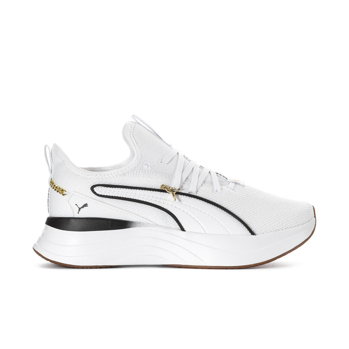 White low-top lace-up sneaker with black stripe and gold accent on chunky sole.