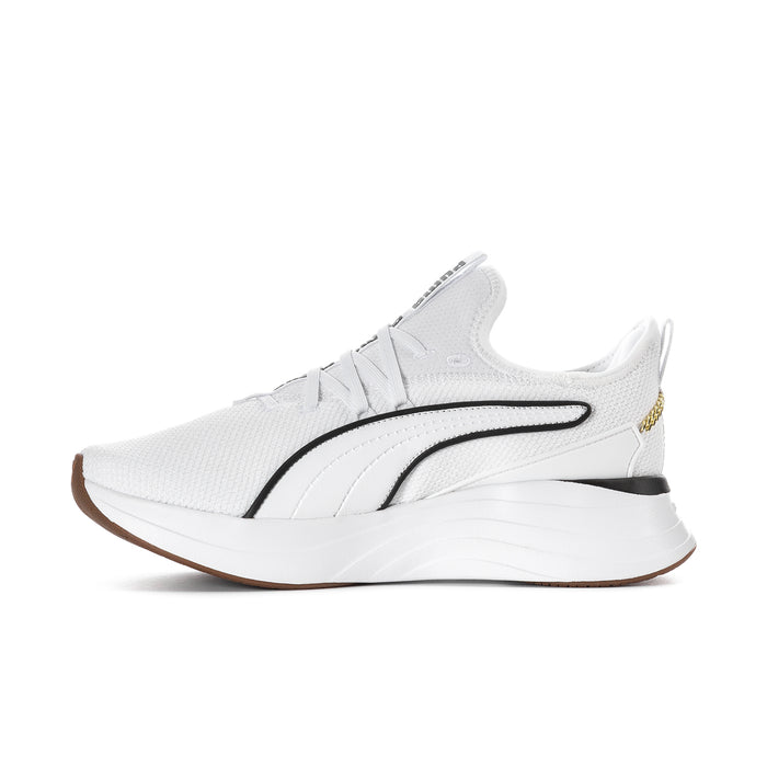 White low-top sneaker profile with black stripe, gold accents, and cushioned midsole.