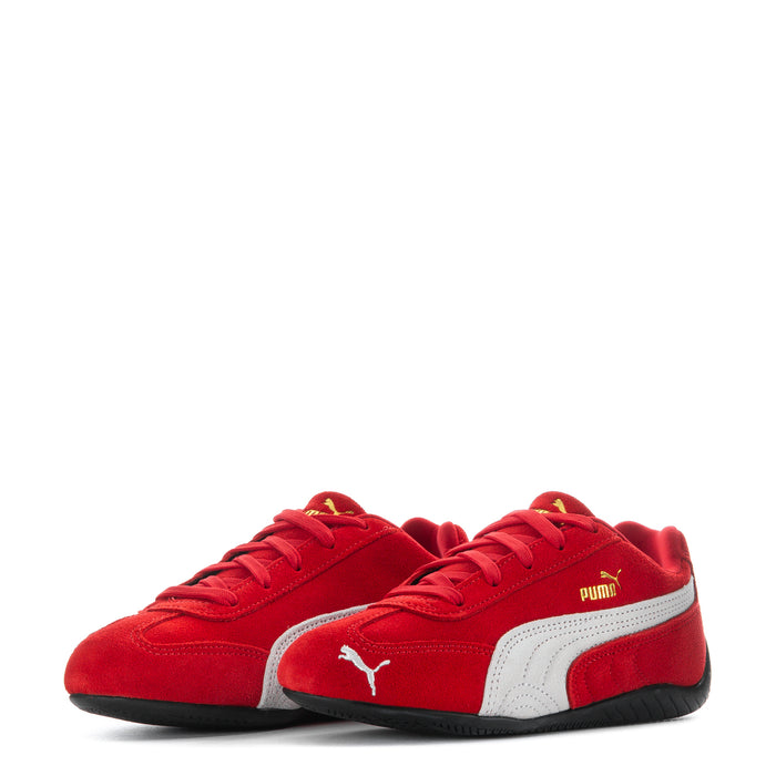 Pair of kids red Puma sneakers with white mid panels and black soles