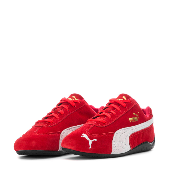 Pair of red and white low-top women's sneakers with Puma logo on vamps