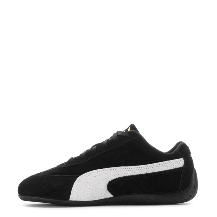 Youth black Puma sneaker with white stripe panel and Puma cat logo on side