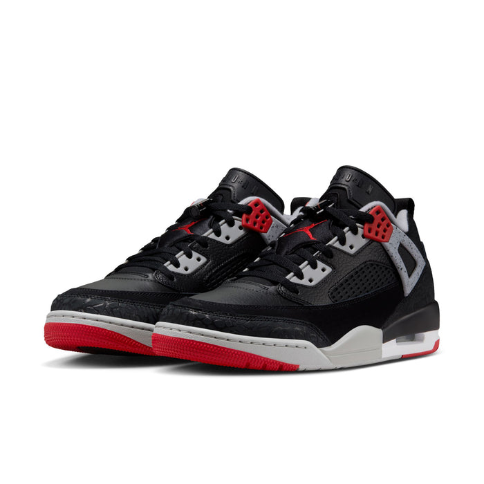 Pair of men's low-top sneakers, black uppers with white details and red soles